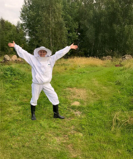 En ung kvinna i biodlingsdräkt